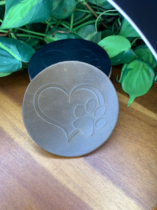 circular leather coaster olive with a heart and paw print stamped in the middle