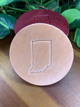 Load image into Gallery viewer, circular leather coaster tan with the state of indiana stamped in the middle
