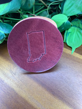 Load image into Gallery viewer, circular leather coaster burgundy with the state of indiana stamped in the middle
