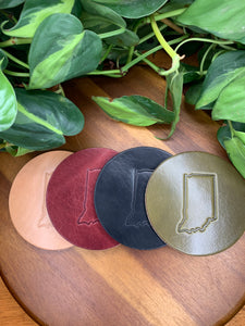 circular leather coaster burgundy black olive tan with a the state of indiana stamped in the middle