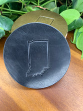 Load image into Gallery viewer, circular leather coaster black with the state of indiana stamped in the middle
